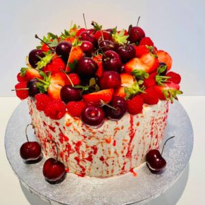 Fruits topped Vanilla sponge cake with raspberry jam and buttercream layers