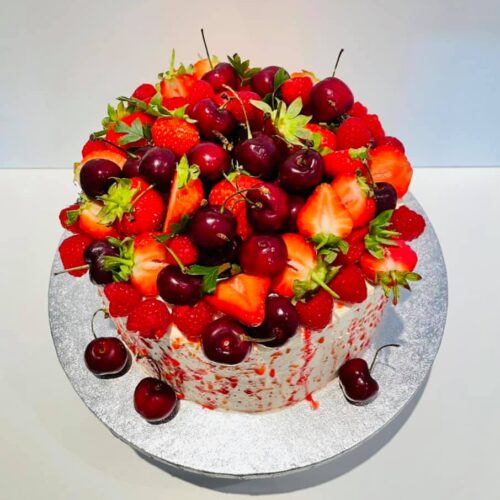 Fruits topped Vanilla sponge cake with raspberry jam and buttercream layers