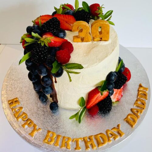 Chocolate Cake with Buttercream and Fresh Fruits Layers, decorated with fresh Seasonal Fruits