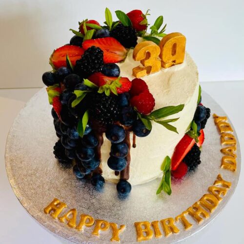 Chocolate Cake with Buttercream and Fresh Fruits Layers, decorated with fresh Seasonal Fruits