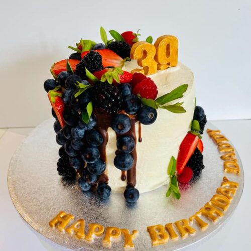 Chocolate Cake with Buttercream and Fresh Fruits Layers, decorated with fresh Seasonal Fruits