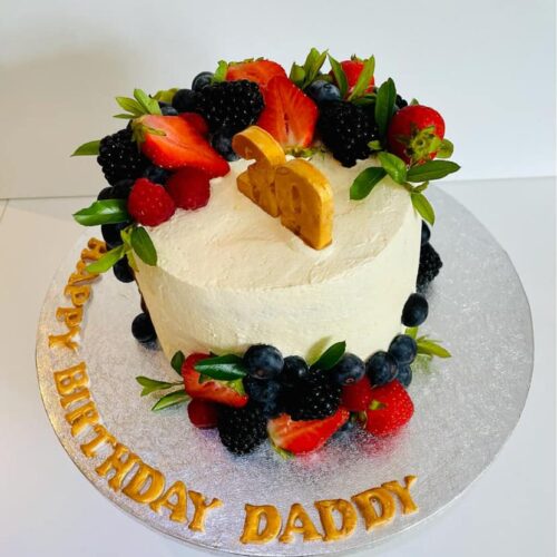 Chocolate Cake with Buttercream and Fresh Fruits Layers, decorated with fresh Seasonal Fruits