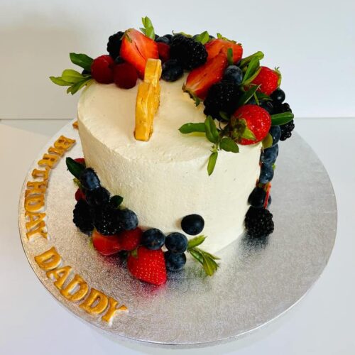 Chocolate Cake with Buttercream and Fresh Fruits Layers, decorated with fresh Seasonal Fruits