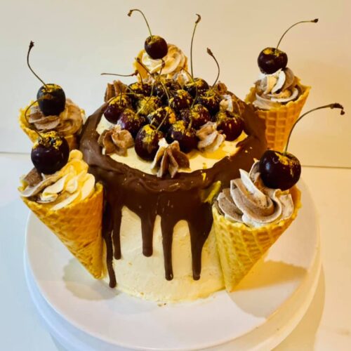 Chocolate Vanilla Sponge Cake with Buttercream and Raspberry Jam Layer, decorated with fresh Cherries