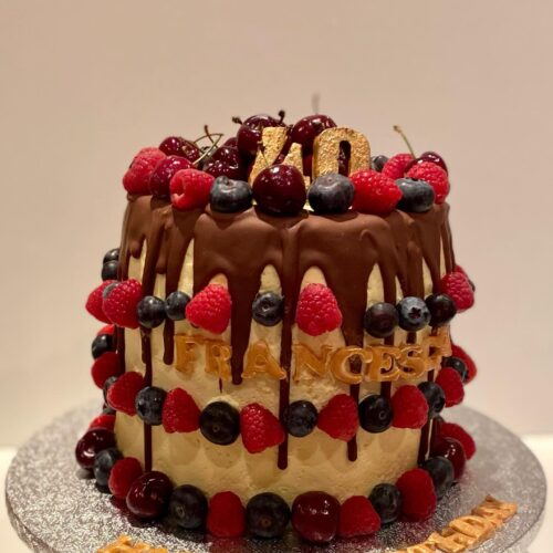 Chocolate Cake with Buttercream filling, decorated with Chocolate drops and Fresh Seasonal Fruits