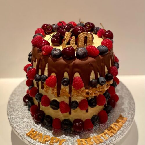 Chocolate Cake with Buttercream filling, decorated with Chocolate drops and Fresh Seasonal Fruits