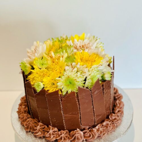 Chocolate Cake decorated with Chocolate Shards and Flowers Topper