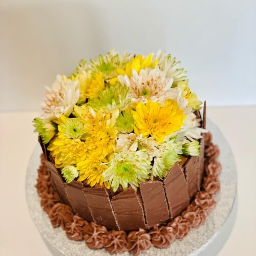Chocolate Cake decorated with Chocolate Shards and Flowers Topper