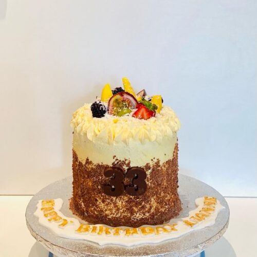 Chocolate Cake with fresh Mango filling and Fruits Toppers with Coconut and Chocolate sprinkles